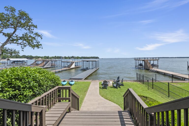 From the back porch, savor uninterrupted views of open water and your private dock—where luxury meets lakeside living.