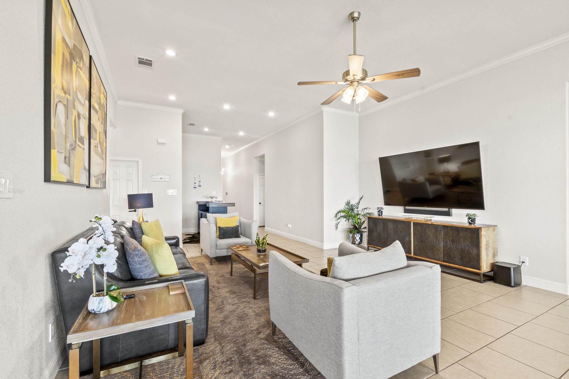 A view of comfortable furniture in the family room and living room with expansive windows with open water views!  Home has very fast internet.