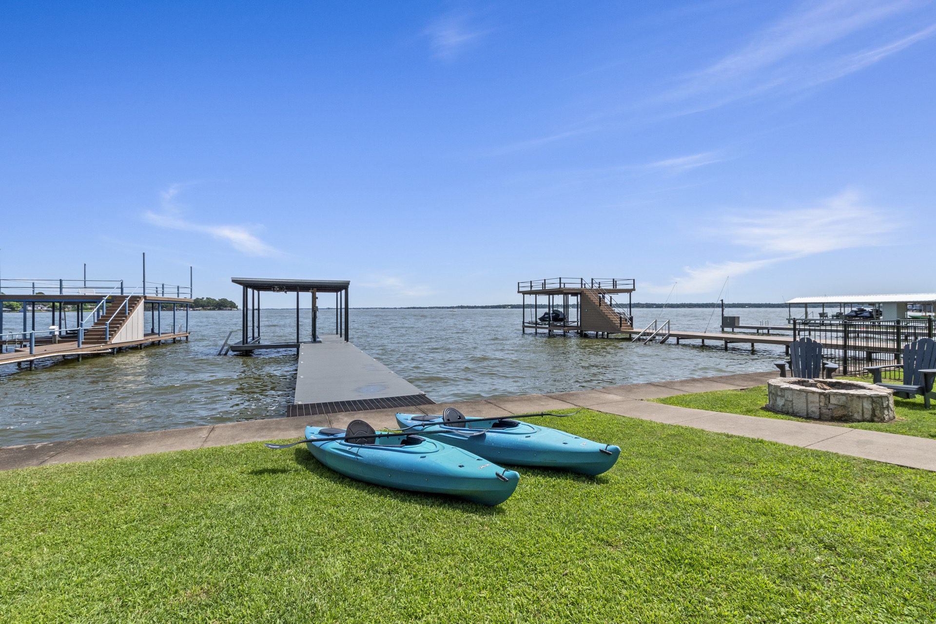 Paddle into adventure—two kayaks ready for you at the dock, with breathtaking open water views of Cedar Creek Lake.