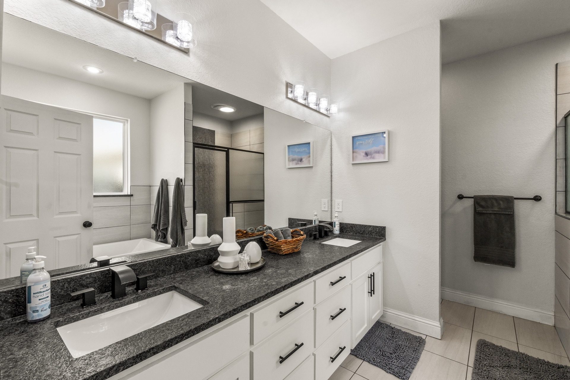 Main bathroom features a luxurious Jacuzzi tub alongside a separate, spacious shower for ultimate relaxation.