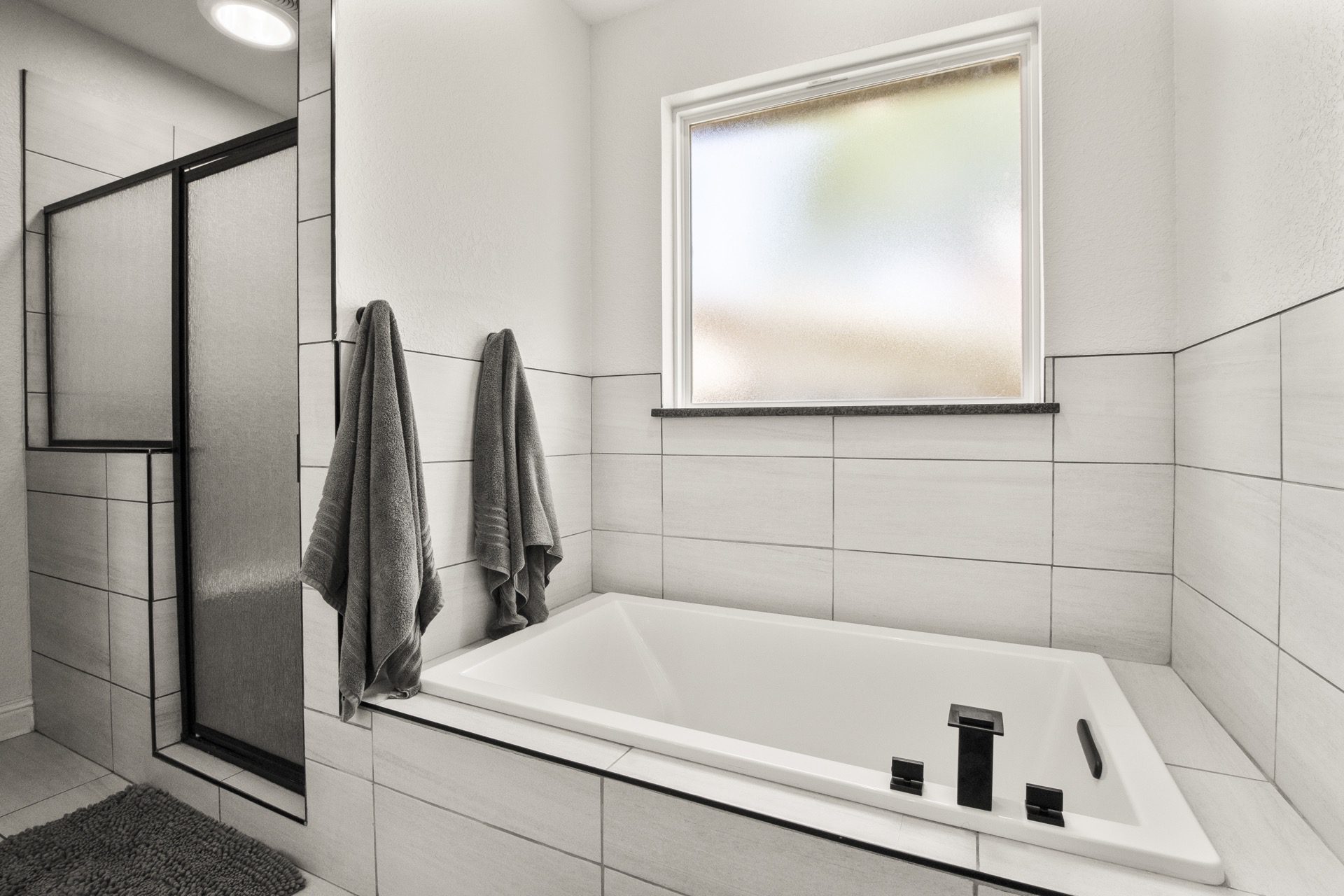 Main bathroom with a separate shower and a relaxing Jacuzzi tub for spa-like comfort.