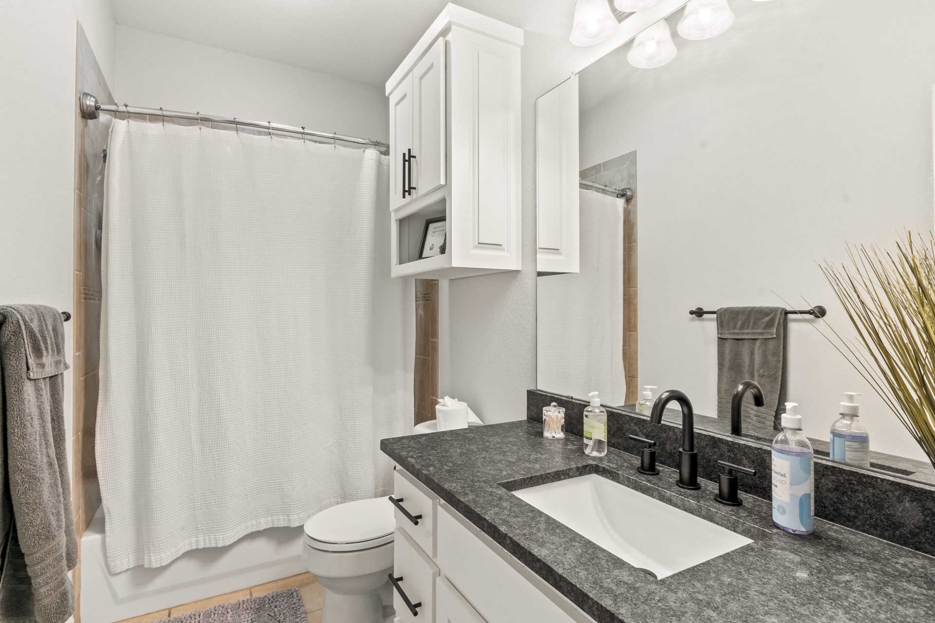 A stylish en-suite bathroom with modern finishes, designed for both comfort and privacy.