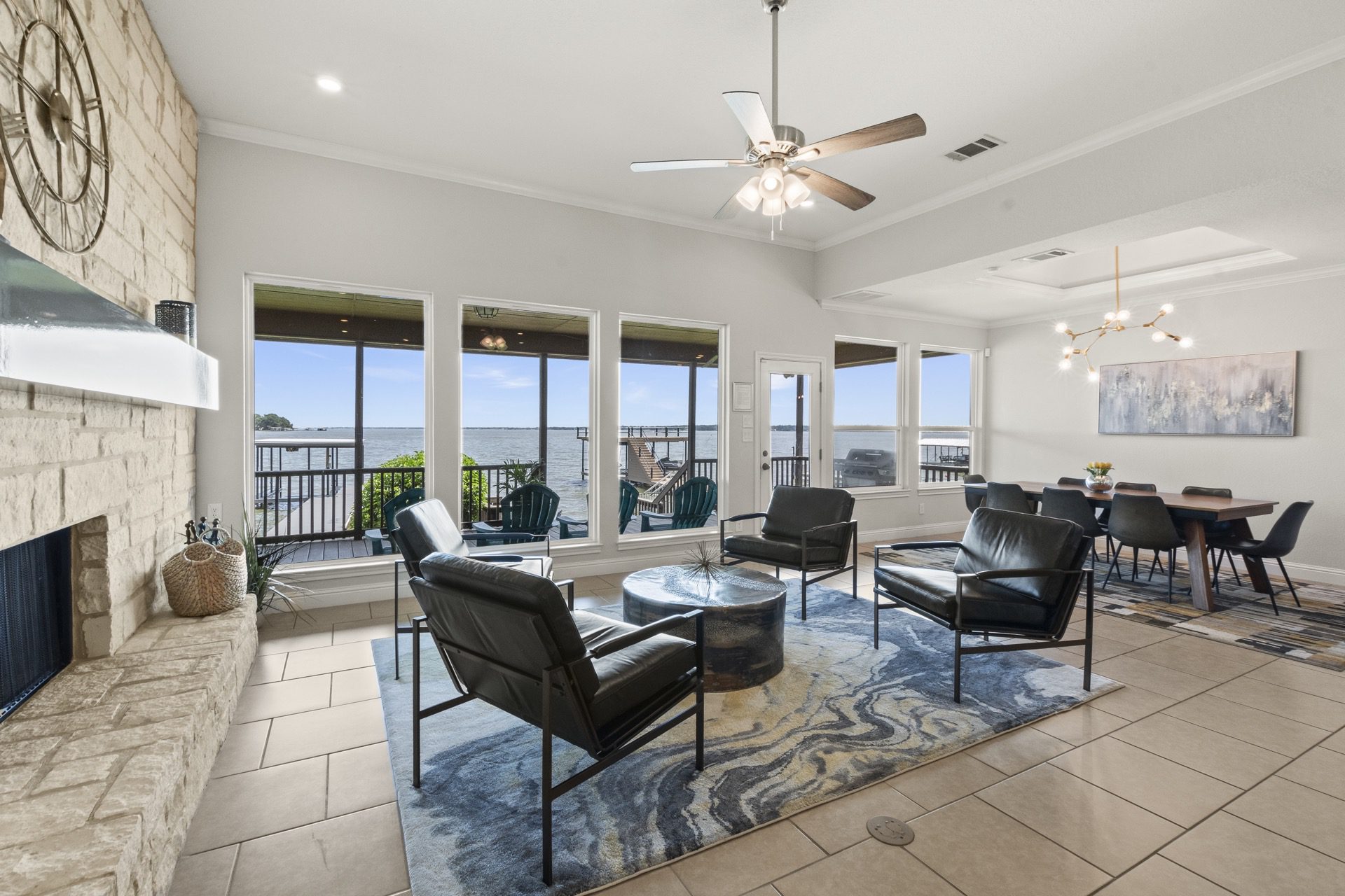 Family room designed for cocktails and conversation, featuring expansive windows with stunning lake views.
