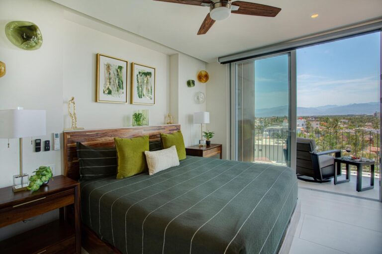 Step onto your private balcony or settle into a swivel chair on the balcony and take in the ocean views — this spacious guest bedroom offers an ensuite bath, generous storage, and a 65" TV for the perfect blend of indoor comfort and outdoor living.